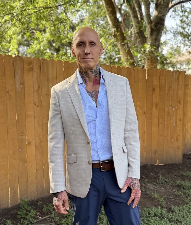 Sam Morris in a light suit jacket, standing outdoors