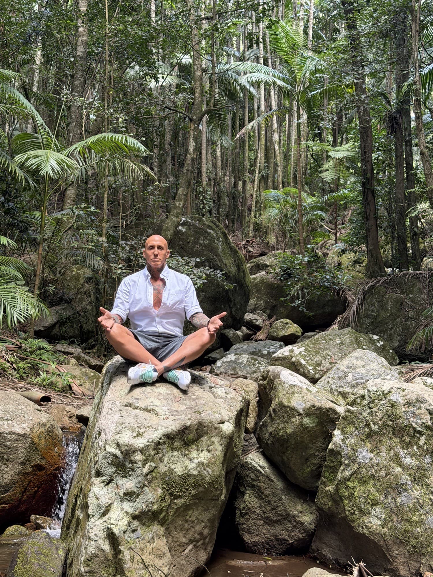 Sam Morris seated in a forest