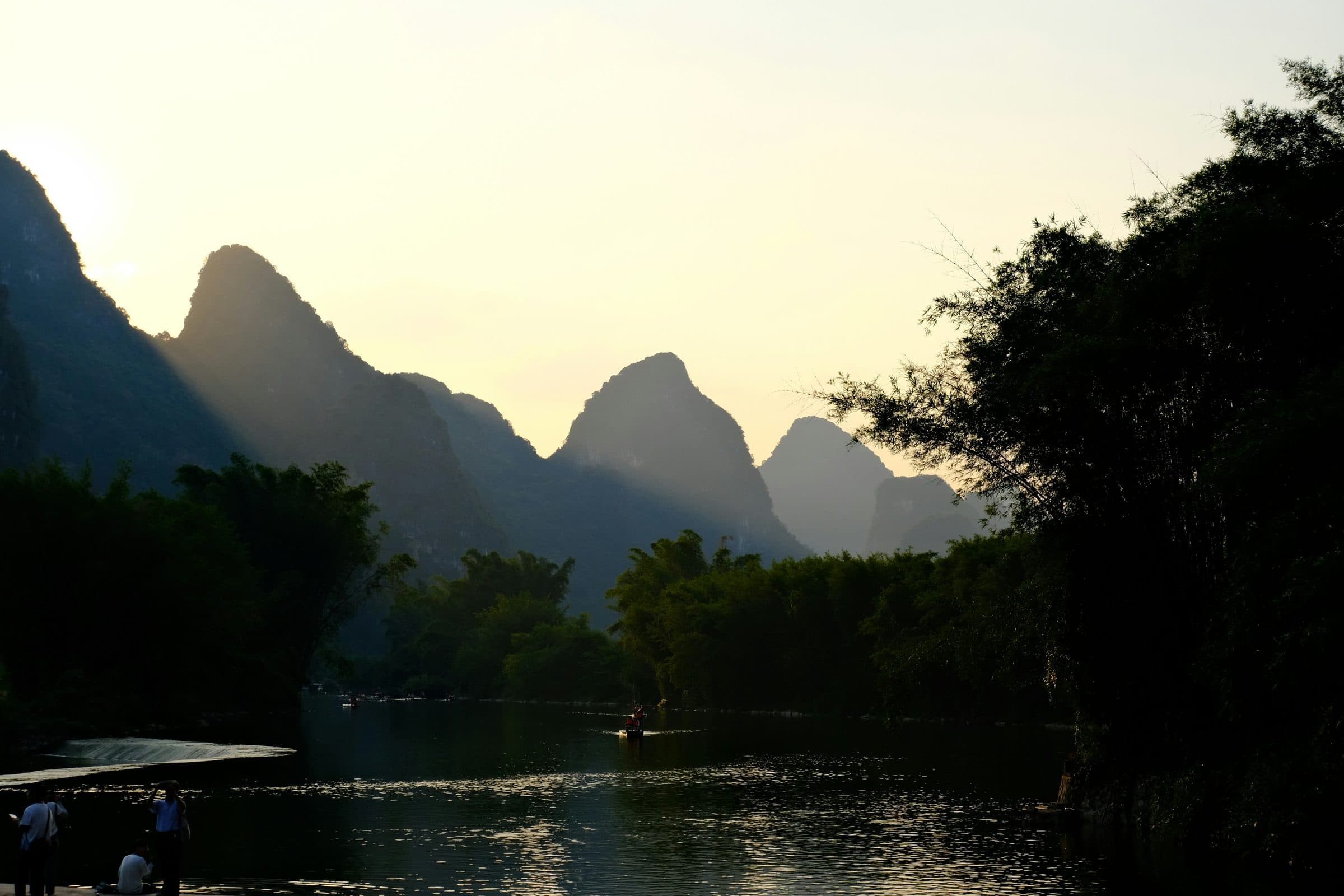 Karst peaks opening one behind the other through morning mist.