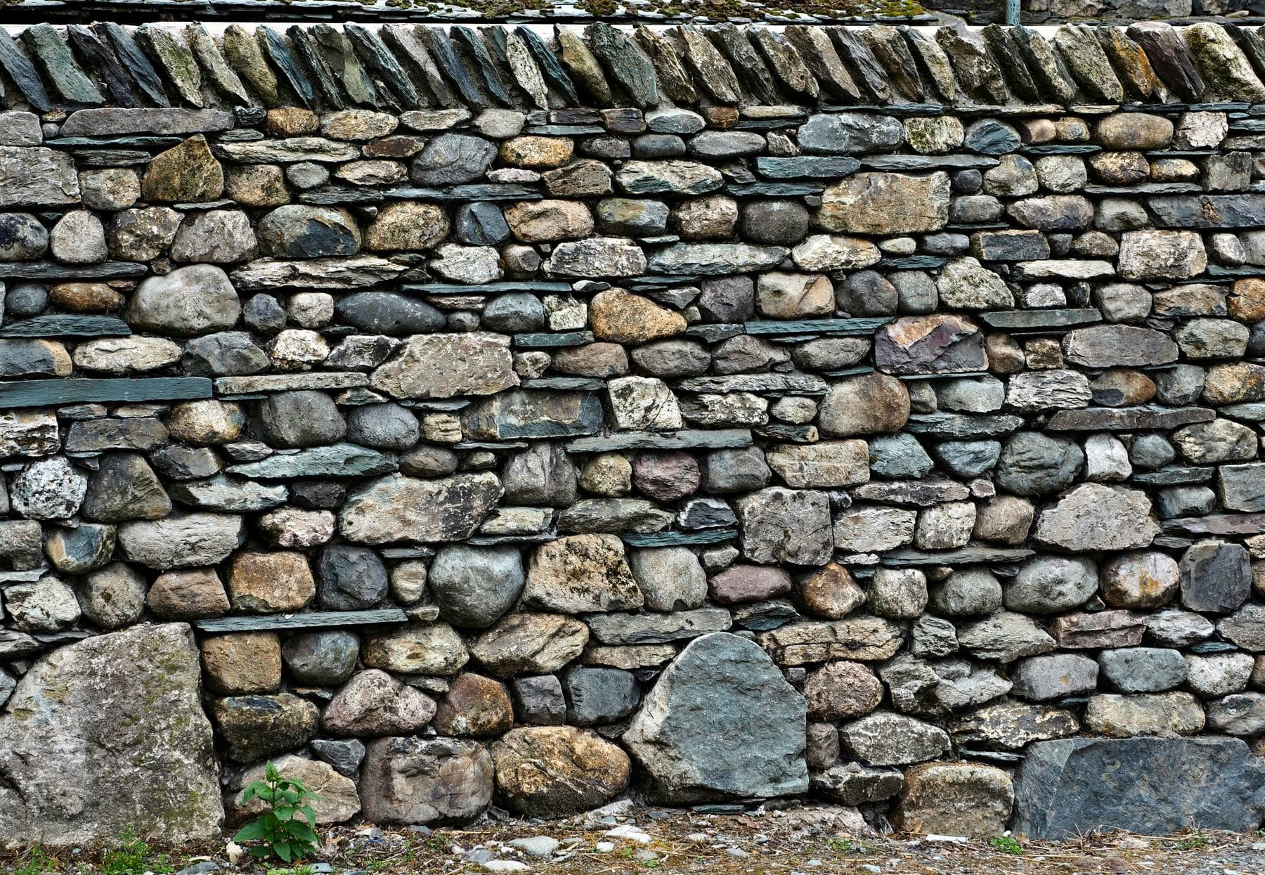 A dry stone wall, each stone set against the next.